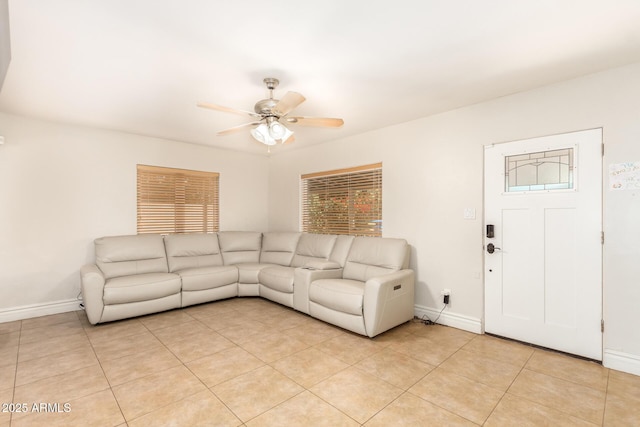 unfurnished living room featuring light tile patterned flooring, baseboards, and ceiling fan