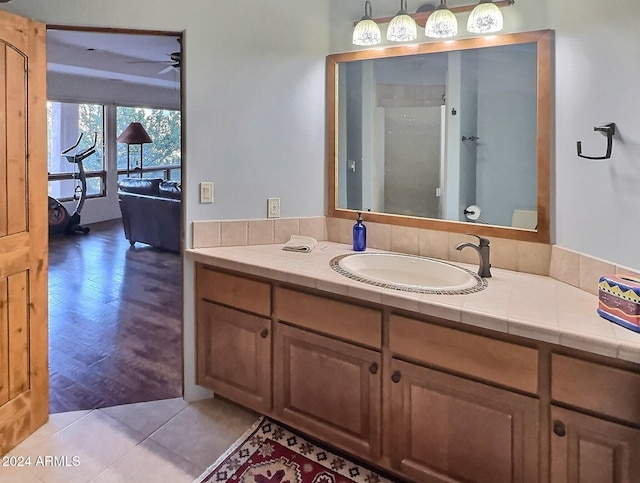 bathroom featuring wood-type flooring, ceiling fan, and vanity