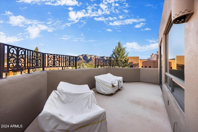 view of patio / terrace with a mountain view and a balcony