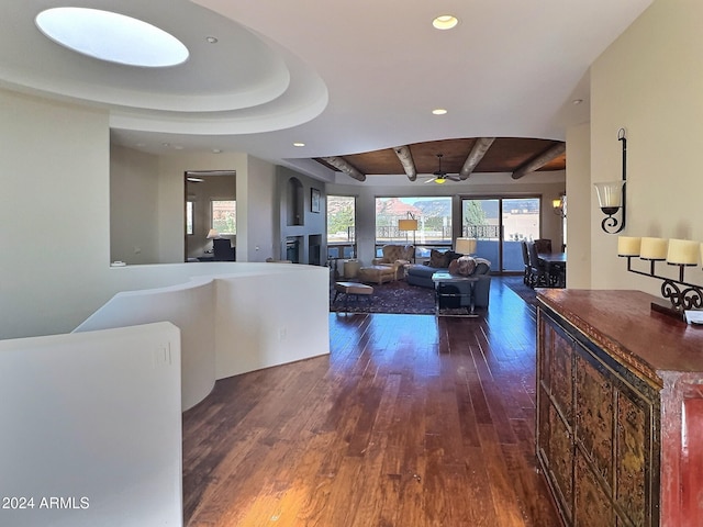 hall with dark wood-type flooring and beamed ceiling