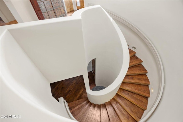 stairs with wood-type flooring