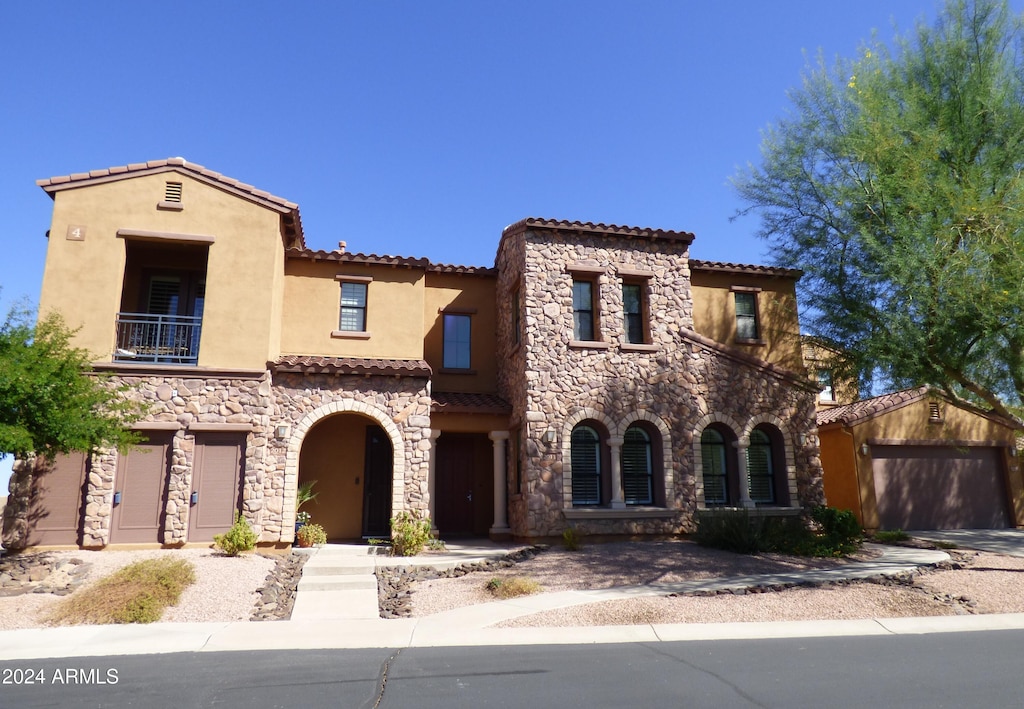 mediterranean / spanish-style home featuring a garage