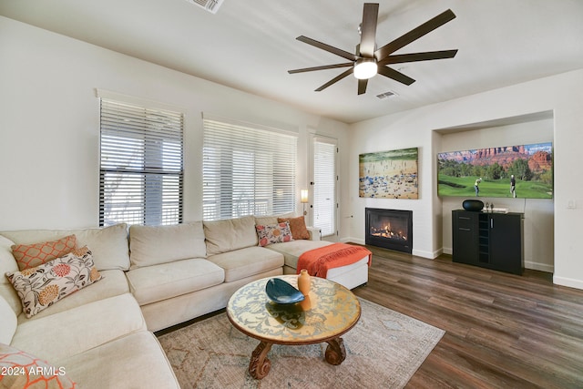 living room with ceiling fan and dark hardwood / wood-style floors