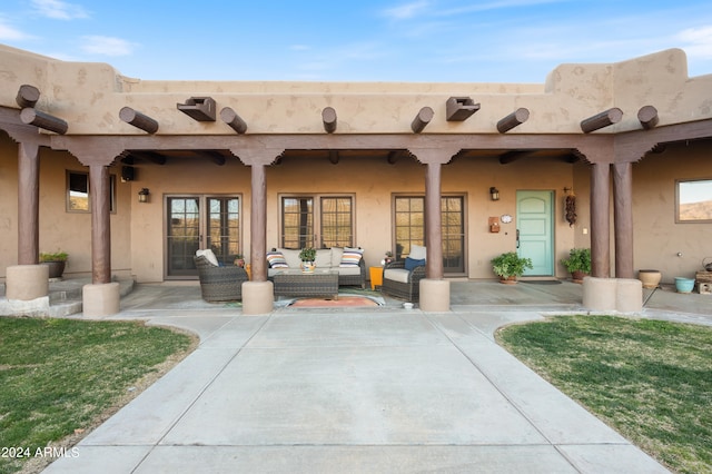 exterior space featuring a patio area, outdoor lounge area, and a yard