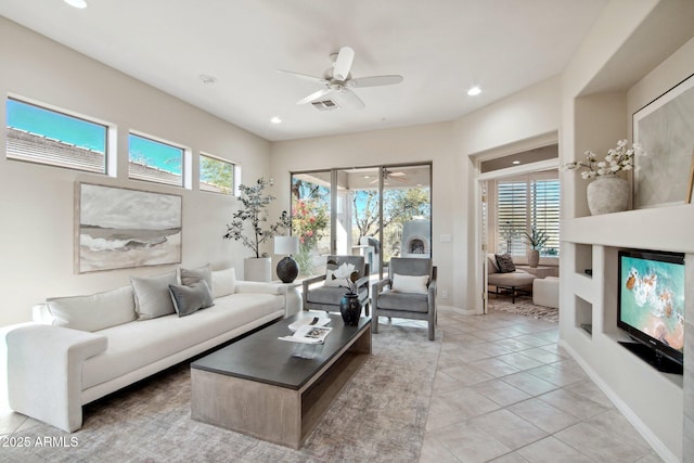 tiled living room with ceiling fan