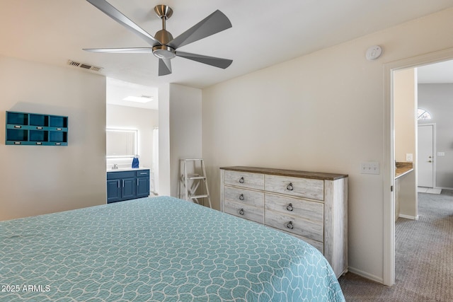 14300 W Bell Rd Unit 312, Surprise, AZ 85374 - carpeted bedroom with baseboards, a ceiling fan, and ensuite bath