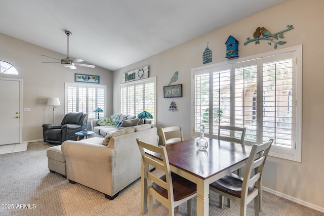 14300 W Bell Rd Unit 312, Surprise, AZ 85374 - dining area with healthy amount of natural light, lofted ceiling, light colored carpet, a ceiling fan, and baseboards