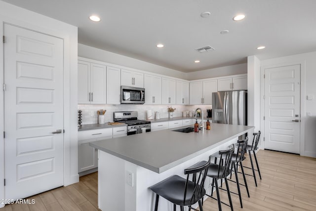 21241 E Superstition Dr, Queen Creek, AZ 85142 - kitchen featuring tasteful backsplash, visible vents, a breakfast bar area, appliances with stainless steel finishes, and a sink