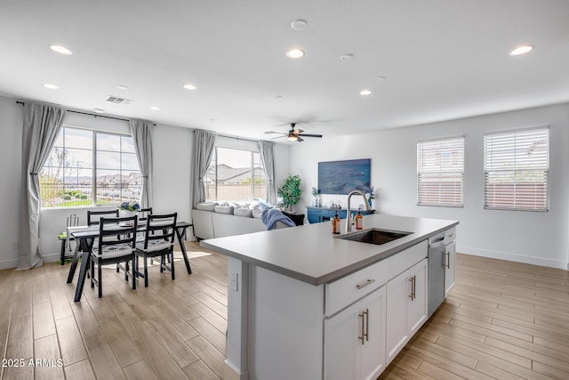 21241 E Superstition Dr, Queen Creek, AZ 85142 - kitchen with a sink, ceiling fan, dishwasher, light wood-style flooring, and a kitchen island with sink