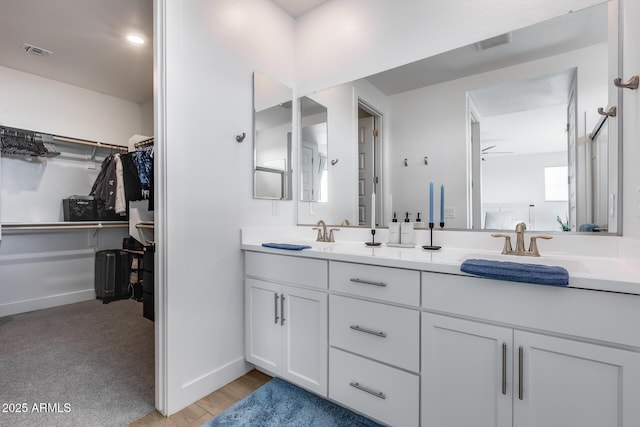 21241 E Superstition Dr, Queen Creek, AZ 85142 - full bath with visible vents, a walk in closet, a sink, double vanity, and baseboards