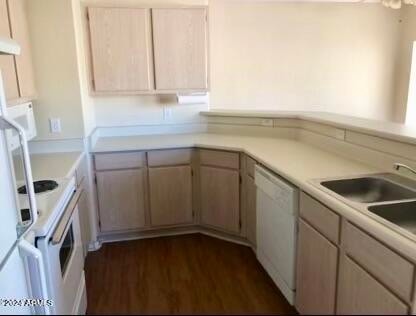 kitchen featuring light brown cabinets, dark hardwood / wood-style flooring, white appliances, and sink