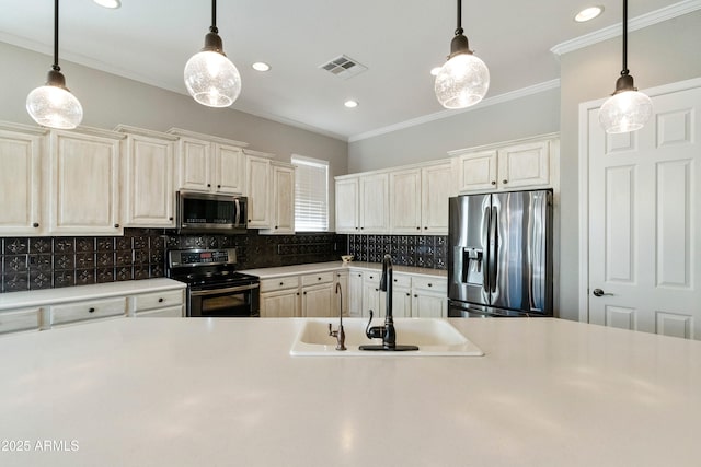 kitchen featuring visible vents, a sink, decorative backsplash, appliances with stainless steel finishes, and crown molding