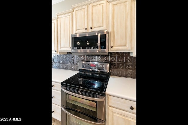 kitchen featuring decorative backsplash, light brown cabinets, stainless steel appliances, and light countertops