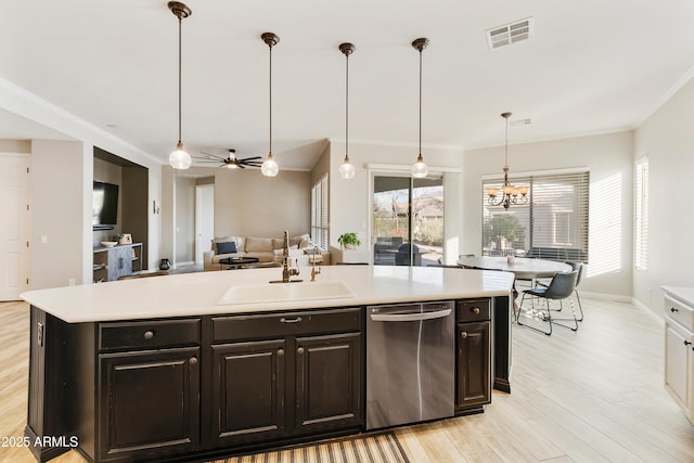 kitchen featuring visible vents, light wood-type flooring, a sink, light countertops, and dishwasher