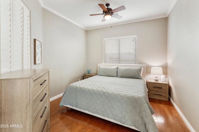 bedroom featuring light wood-style flooring, baseboards, and ornamental molding