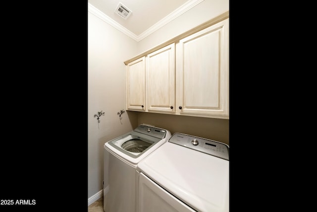 laundry room with visible vents, baseboards, washing machine and dryer, ornamental molding, and cabinet space