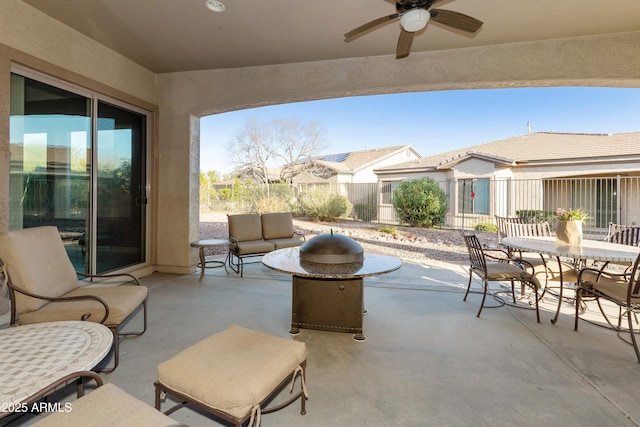 view of patio / terrace with outdoor dining area, fence, and ceiling fan