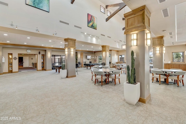 dining area with visible vents, baseboards, decorative columns, recessed lighting, and a towering ceiling