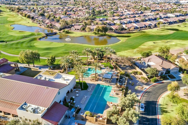 aerial view featuring a residential view, golf course view, and a water view