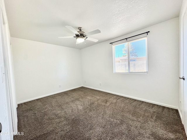 unfurnished room featuring ceiling fan, dark carpet, and a textured ceiling