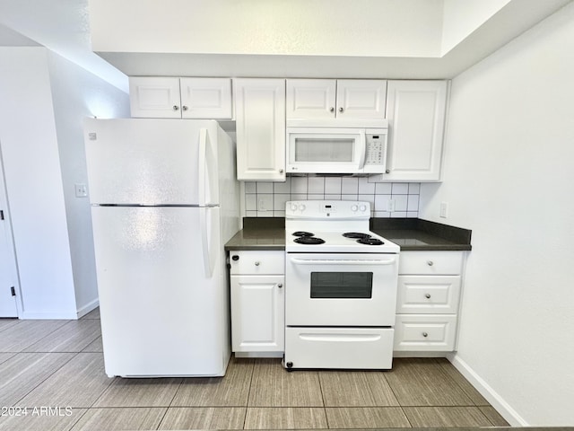 kitchen featuring backsplash, white cabinetry, and white appliances