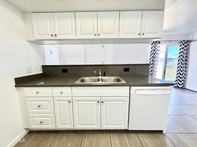 kitchen featuring light wood-type flooring, white dishwasher, white cabinetry, and sink