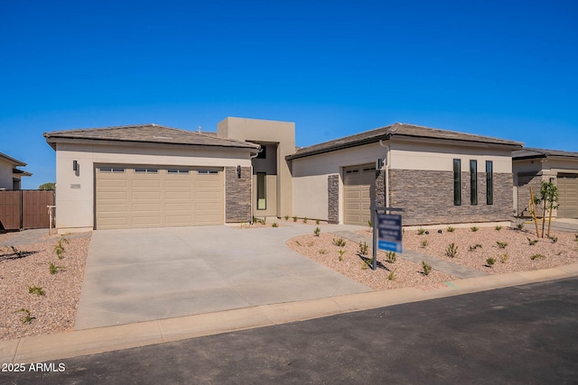 24022 S 218th Pl, Queen Creek, AZ 85142 - prairie-style home with driveway, an attached garage, stucco siding, and stone siding