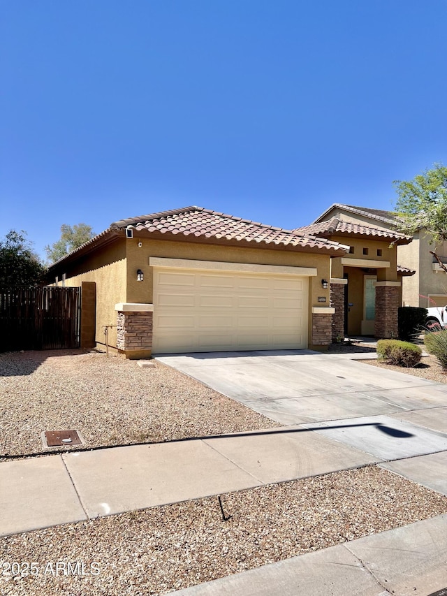 16559 W Lincoln St, Goodyear, AZ 85338 - view of front of home featuring stucco siding, concrete driveway, a garage, and a tile roof