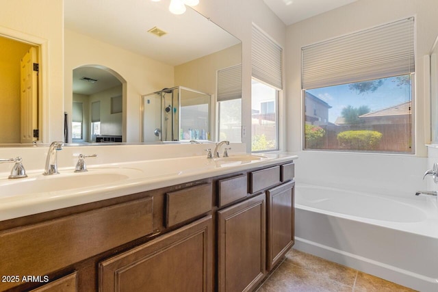 16559 W Lincoln St, Goodyear, AZ 85338 - full bathroom featuring a shower stall, a garden tub, tile patterned floors, and double vanity