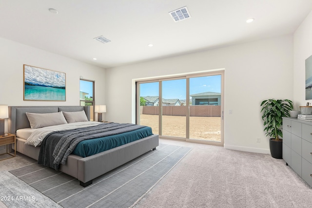 carpeted bedroom featuring access to outside