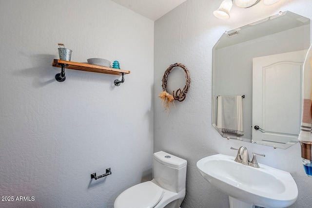 bathroom with toilet and sink