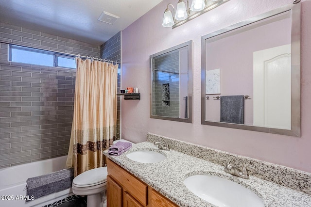 full bathroom featuring toilet, vanity, and shower / tub combo with curtain