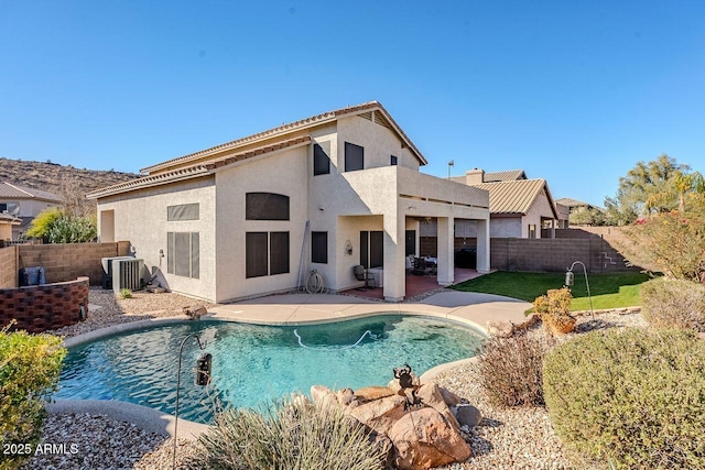 back of house featuring a fenced in pool, central AC unit, and a patio