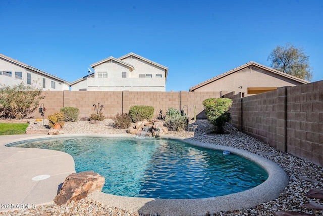 view of swimming pool with pool water feature