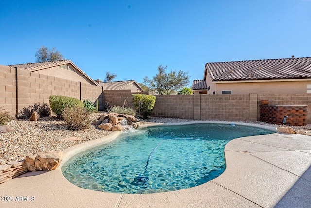 view of swimming pool with pool water feature