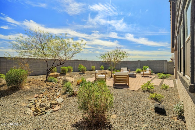 view of yard featuring a patio, a fenced backyard, and an outdoor fire pit