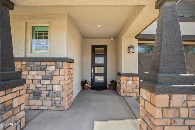 property entrance with stucco siding