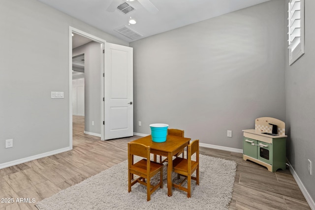 playroom featuring visible vents, baseboards, ceiling fan, and wood finished floors