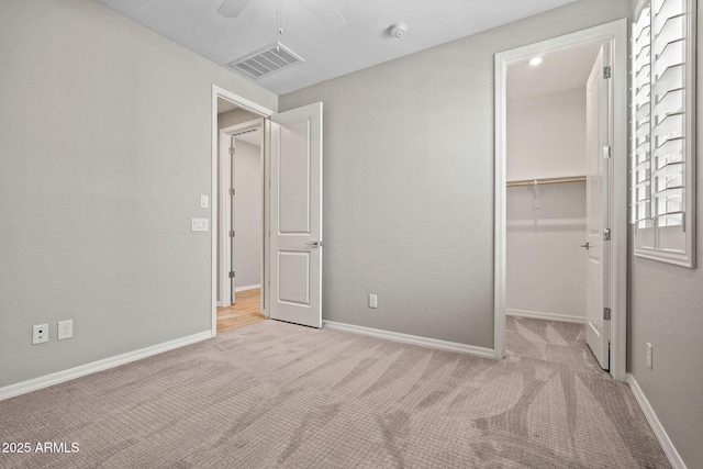 unfurnished bedroom with carpet flooring, baseboards, and visible vents