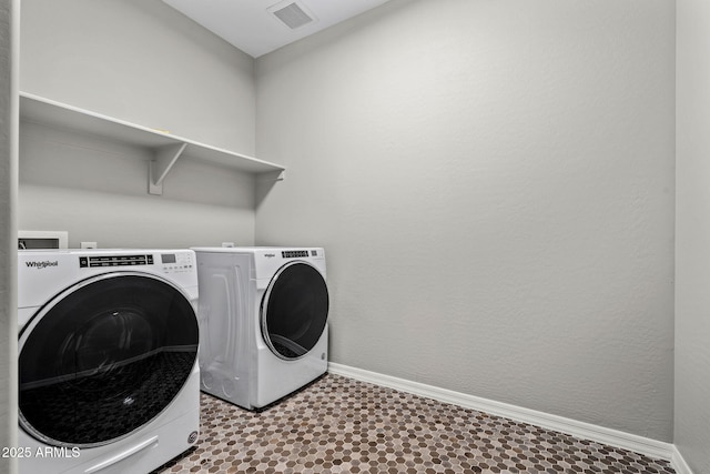 laundry room with visible vents, baseboards, laundry area, tile patterned floors, and separate washer and dryer