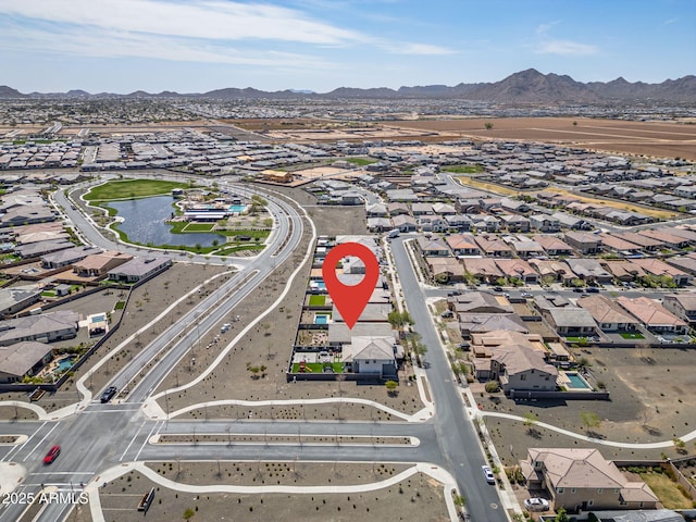 drone / aerial view featuring a residential view and a water and mountain view