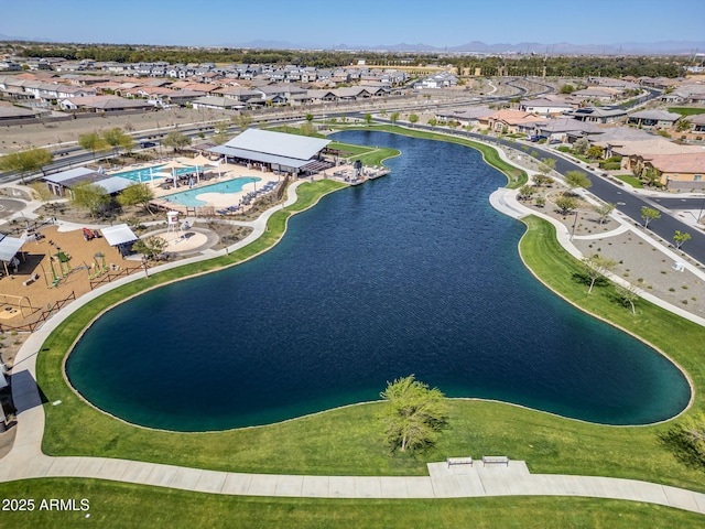 birds eye view of property with a water view and a residential view