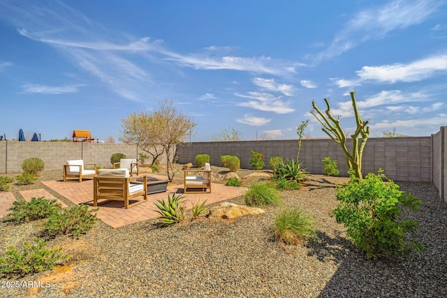 view of yard with an outdoor living space, a patio area, and a fenced backyard