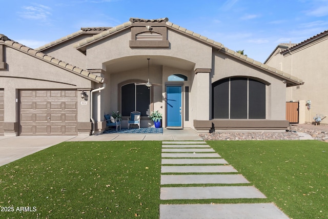 exterior space with a garage, a yard, driveway, and stucco siding