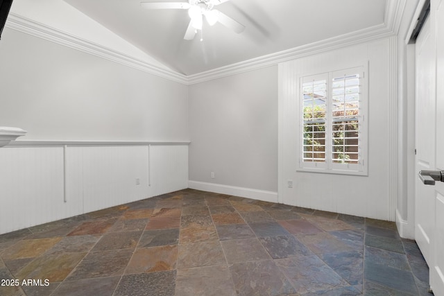 empty room featuring lofted ceiling, ceiling fan, ornamental molding, and stone tile floors