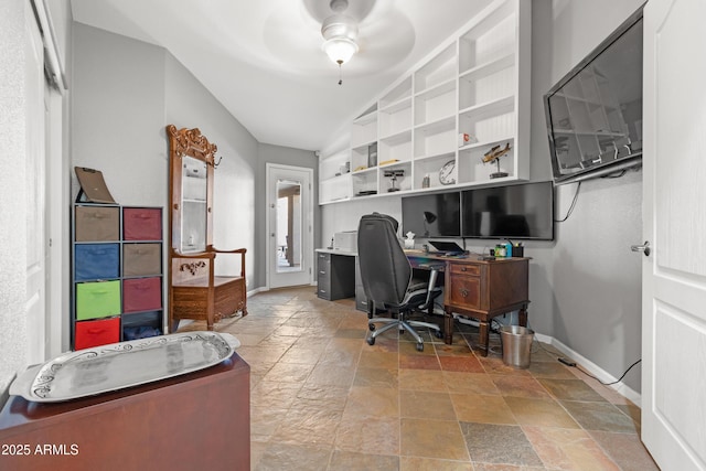 office area featuring stone tile floors, baseboards, and a ceiling fan