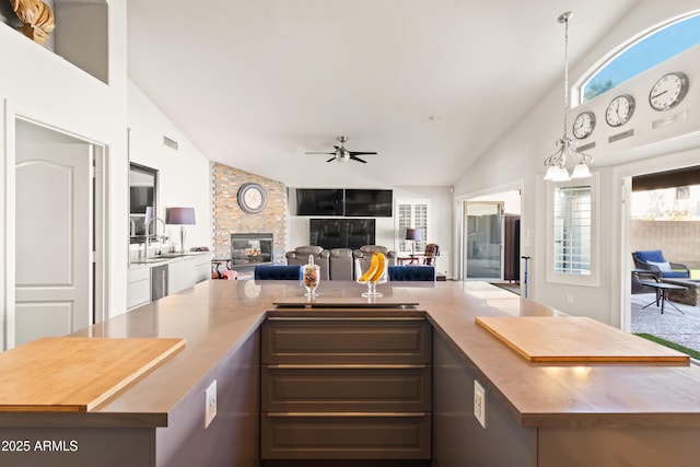 kitchen featuring open floor plan, light countertops, and vaulted ceiling