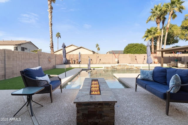 view of patio / terrace with an outdoor living space with a fire pit and a fenced backyard