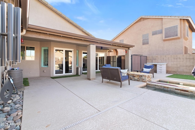 view of patio / terrace with a fire pit and fence
