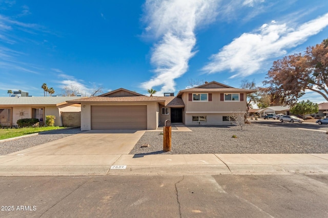 split level home featuring driveway and an attached garage